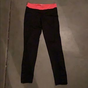 Black leggings with pink band around the waste